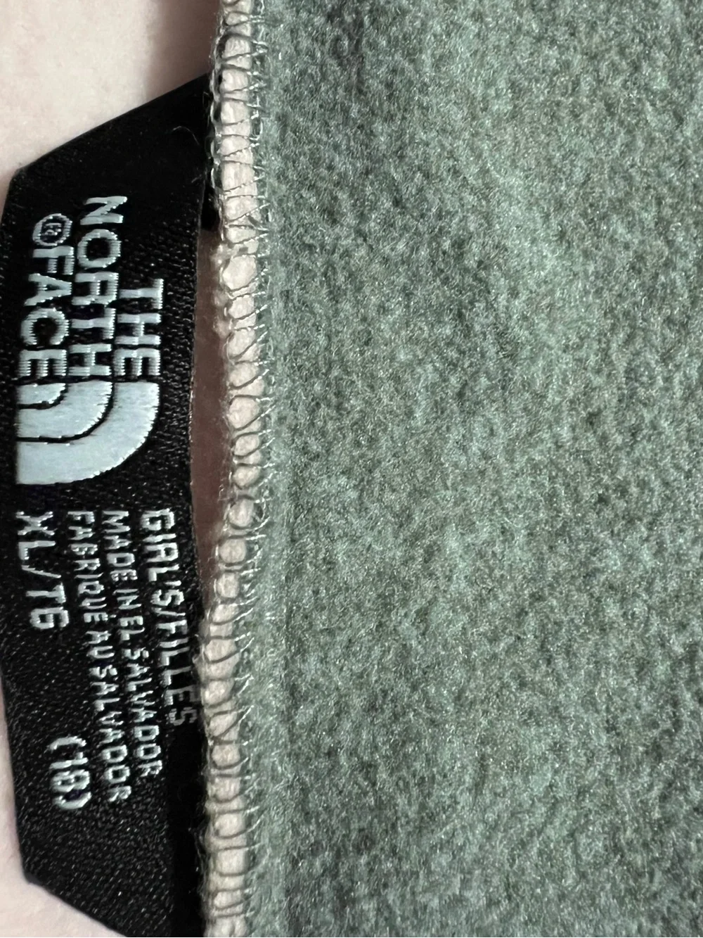 The North Face Girls' Fleece Pullover in grey and pink.